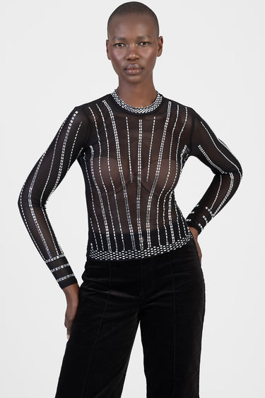 sheer black long sleeve top with white beaded vertical stripes and crew neck worn by a model