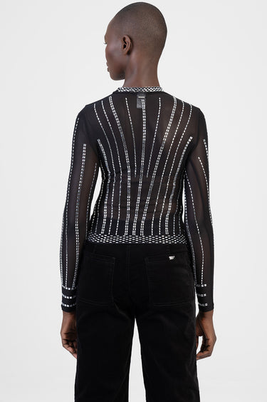 back view of a sheer black long sleeve top with white vertical stitched lines and a patterned collar, paired with black pants