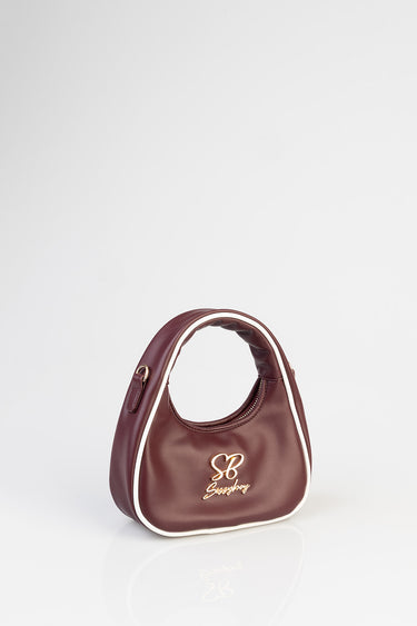 Blue Jean Traders burgundy mini bag with white piping and gold logo on front curved top handle design