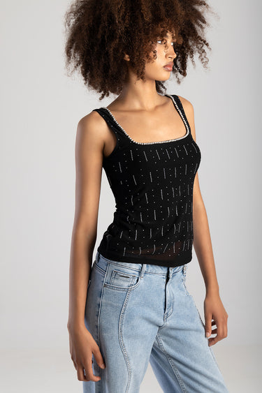Blue Jean Traders black knit sleeveless top with beaded square neckline and dotted pattern, paired with light wash jeans