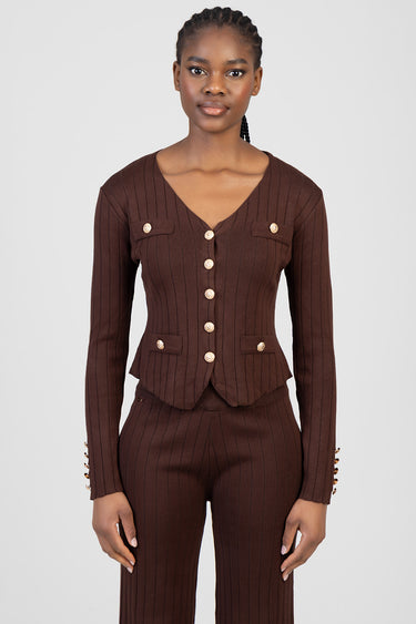 woman in brown ribbed knit cardigan with gold buttons and pocket details, paired with matching knit pants