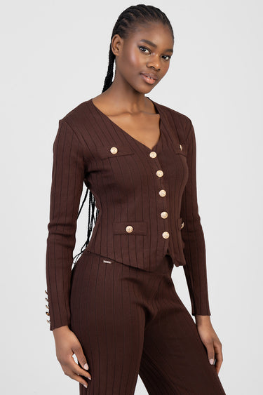 woman wearing a brown pinstriped knit cardigan with gold buttons and matching knit pants with chest pockets