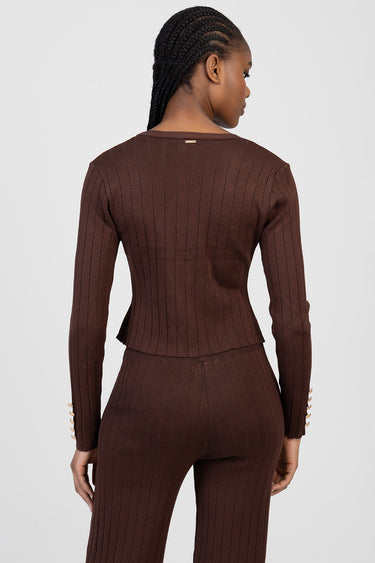 back view of a brown ribbed knit cardigan with long sleeves and gold button details, worn with matching knit pants