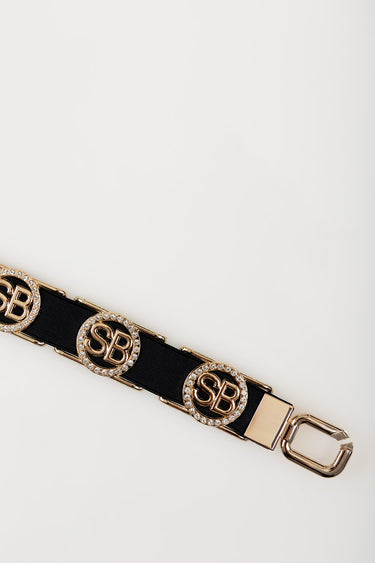 black belt with gold circular crystal encrusted buckles and a metal clip end