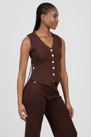 Blue Jean Traders knit waistcoat worn by a woman in brown ribbed fabric with gold buttons, matching knit trousers.