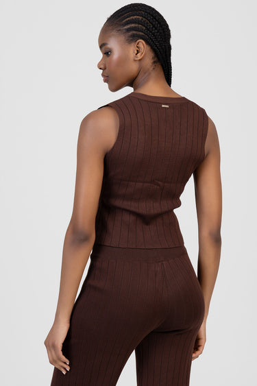 back view of a woman in a brown ribbed knit sleeveless waistcoat and matching trousers