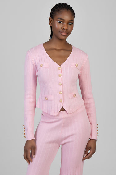 pink ribbed knit cardigan with gold buttons paired with matching pink trousers on a model