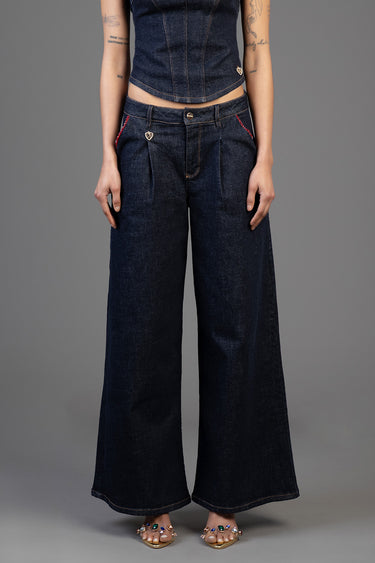woman wearing dark wash wide leg jeans with red stitched pockets and heart charm, paired with a cropped denim top