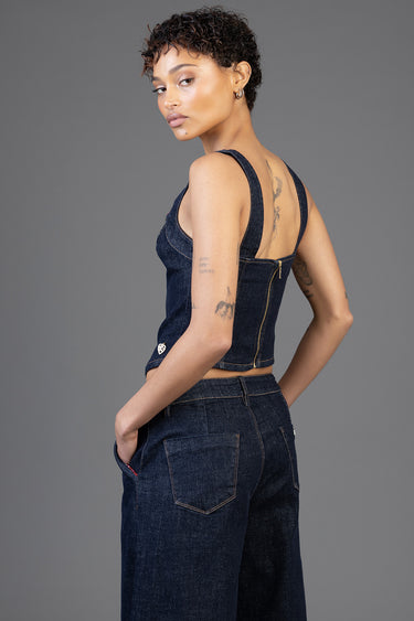 model in dark denim top with zipper back and wide leg jeans, side view