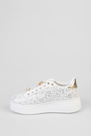 white lace sneakers by blue jean traders featuring a gold heel tab and pearl eyelets with a thick platform sole