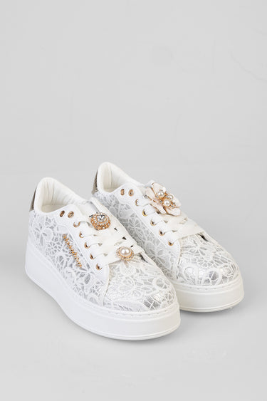 white lace sneakers with gold eyelets, decorative pearl and crystal flower charms, and a thick white sole
