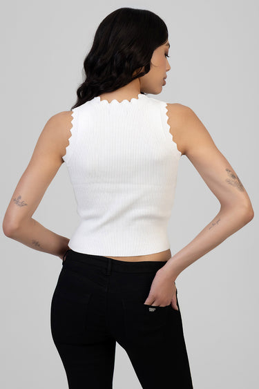 white ribbed knit sleeveless top with scalloped edges, back view on a model wearing black jeans