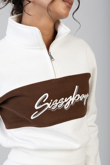 white and brown half zip track top with speckled fabric and rhinestone script across the chest