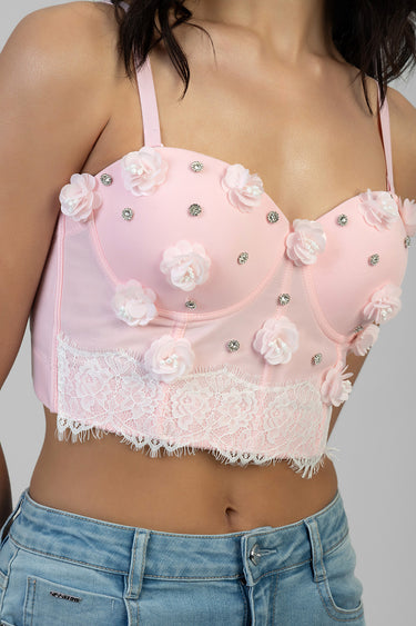 pink corset style top with floral appliques and rhinestones, lace trim at hem, worn with jeans