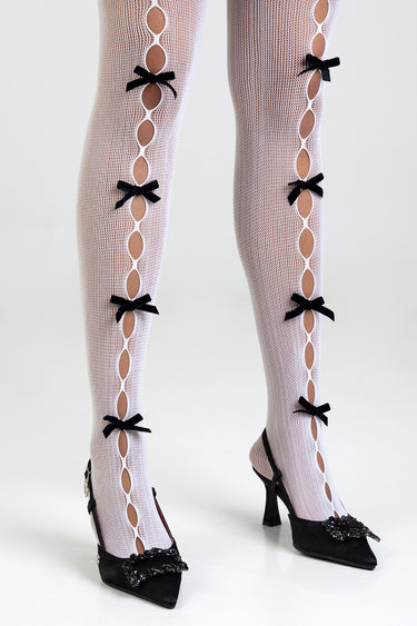 white fishnet stockings with vertical oval cutouts and small black bows down the legs, paired with black heeled shoes