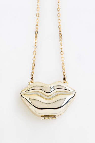 gold tone lip shaped pendant on a delicate chain necklace