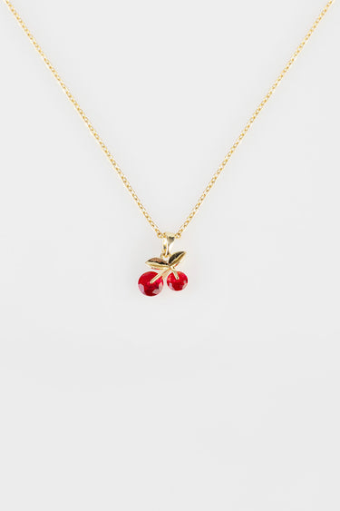 gold tone chain necklace with a cherry pendant showing two red gems and a gold leaf