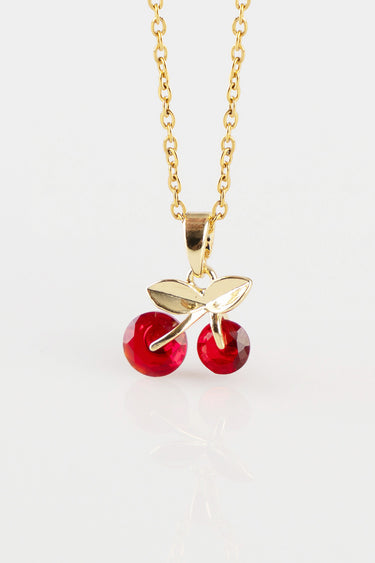 gold tone chain with cherry pendant showing two red stones and a gold leaf