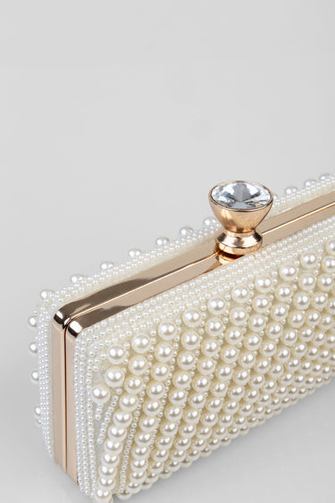 pearl covered clutch with gold frame and a large crystal clasp