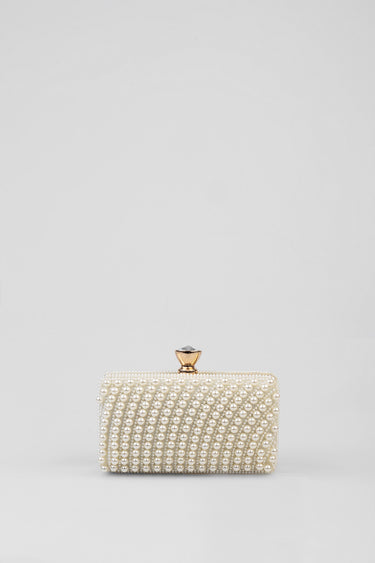 pearl embellished clutch bag with a gold tone knob clasp on a light grey background