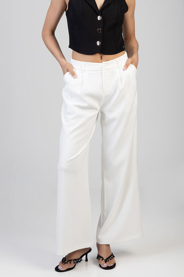 woman in white wide leg trousers with a high waist and front pleats, paired with a black cropped sleeveless top and black