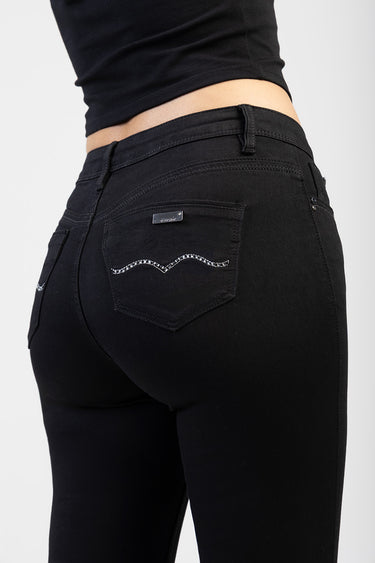 Blue Jean Traders black skinny jeans viewed from the back with rhinestone wave stitching on the rear pocket and a metal