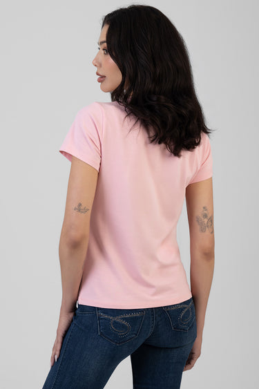 back view of a light pink short sleeve t shirt on a woman with dark blue jeans