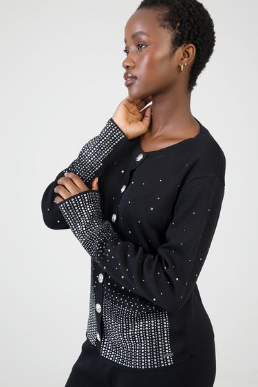 woman in black knit cardigan with rhinestone embellishments on cuffs and front panels, silver buttons