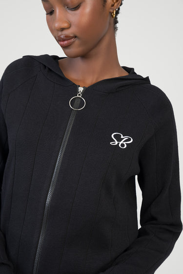 black knit jacket with hood, silver zip pull ring, and small white embroidered logo on the chest