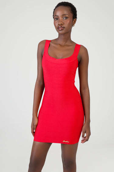 model wearing a bright red sleeveless bodycon mini dress with a scoop neckline and horizontal seam bands, gold logo at the
