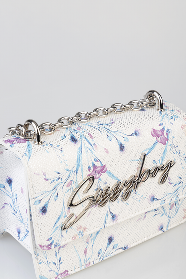 white floral bag with blue and pink print, silver chain strap and metallic script logo on front