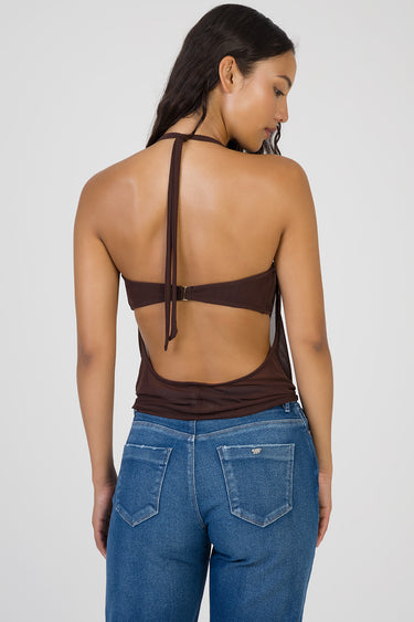 back view of a woman in a brown halter top with an open back and a small clasp, paired with blue jeans