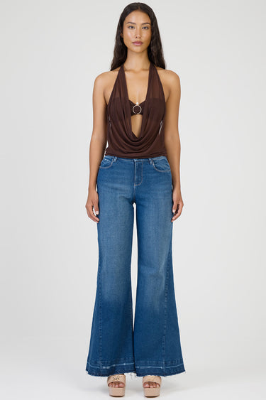 brown halter draped top with cutout and ring detail, paired with blue wide-leg jeans and beige platform sandals