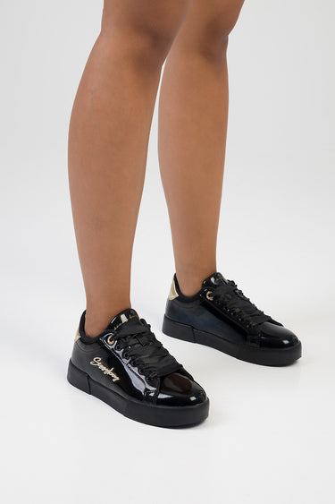 black patent sneakers with lace up front and gold heel detail, visible logo on the side
