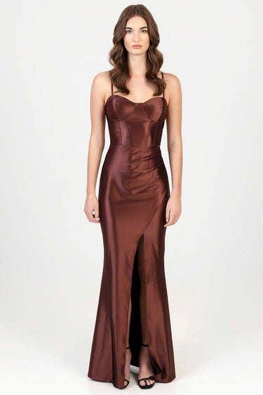 woman models a burgundy satin maxi dress with thin straps, structured bodice and waist, and a front split, paired with