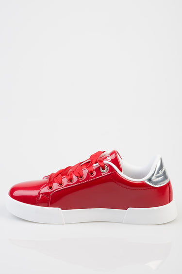 Blue Jean Traders red patent sneakers with white sole and silver heel, side view.