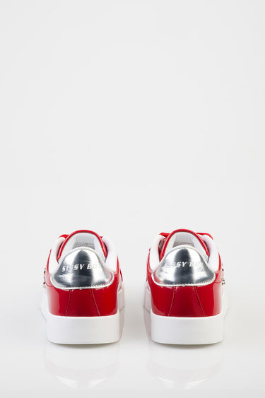 rear view of red patent sneakers with white sole and silver heel patch