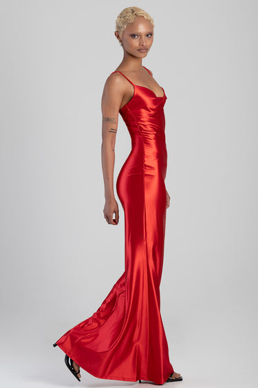 model wearing red satin maxi dress with thin straps and a long train in profile