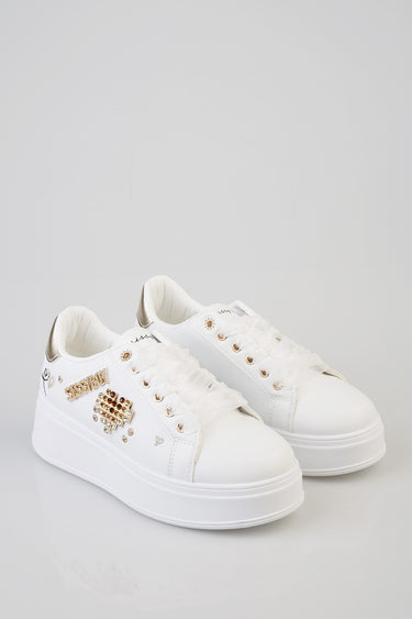 white sneakers with chunky platform sole and gold rhinestone and stud embellishments on the side