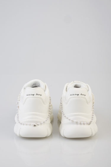 white sneakers with pearl chain along the back and a stitched sissy boy logo on the heel