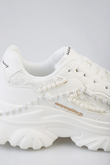white sneakers by Blue Jean Traders featuring lace panels, pearl chain accents and a chunky white sole