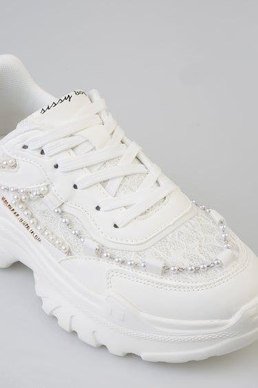 white sneakers with pearl bead embellishments along the sides, lace details, and a chunky sole with mesh panels