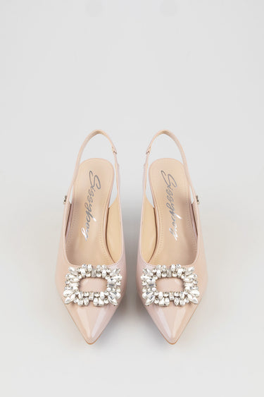 nude pink slingback heels with pointed toes and a large crystal buckle on the vamp