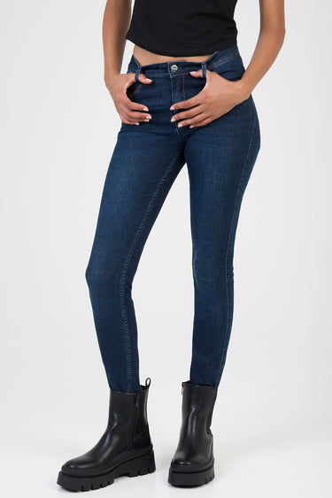 woman in dark blue skinny jeans with a black top and chunky black boots