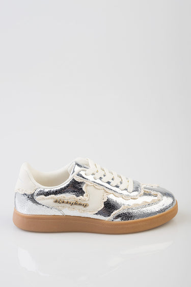 silver metallic sneakers with white laces, beige panels, a gold script logo on the side, and a gum rubber sole
