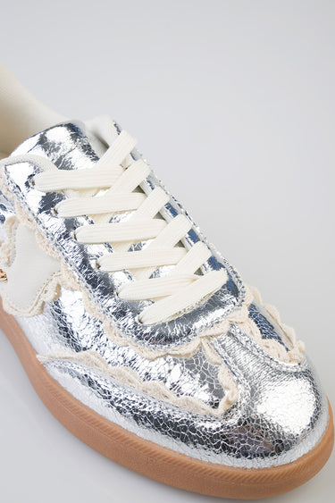 metallic silver sneaker with cracked leather texture, cream laces, beige fringe trim and gum sole