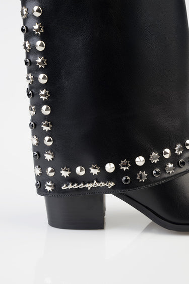 black leather boot with silver and black studded stars along the edge and a chunky block heel
