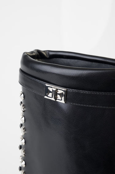 black leather boot with silver studs along the side and a small metal buckle at the cuff