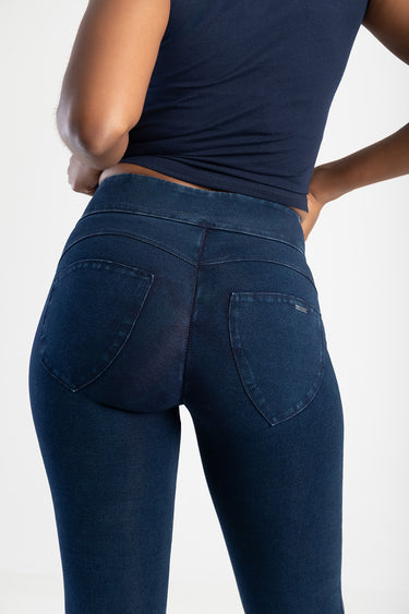 woman in dark indigo skinny denim jeans seen from behind with two back pockets