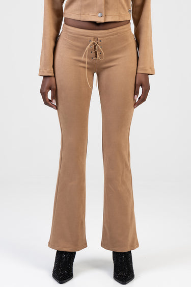 tan faux suede flare leg pants with lace up front and high waist, paired with black glitter boots